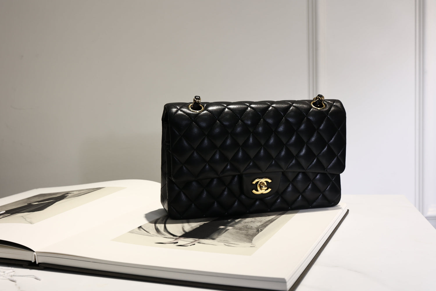 Chanel classic flap black lambskin bag on table styling luxury look