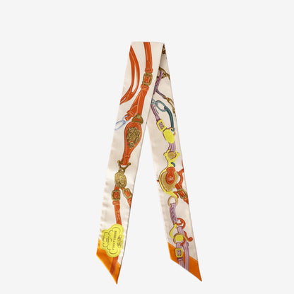 Title: Hermès Brides de Gala Appliqué Piqué Twilly in Crème/Orange/Jaune Silk front view