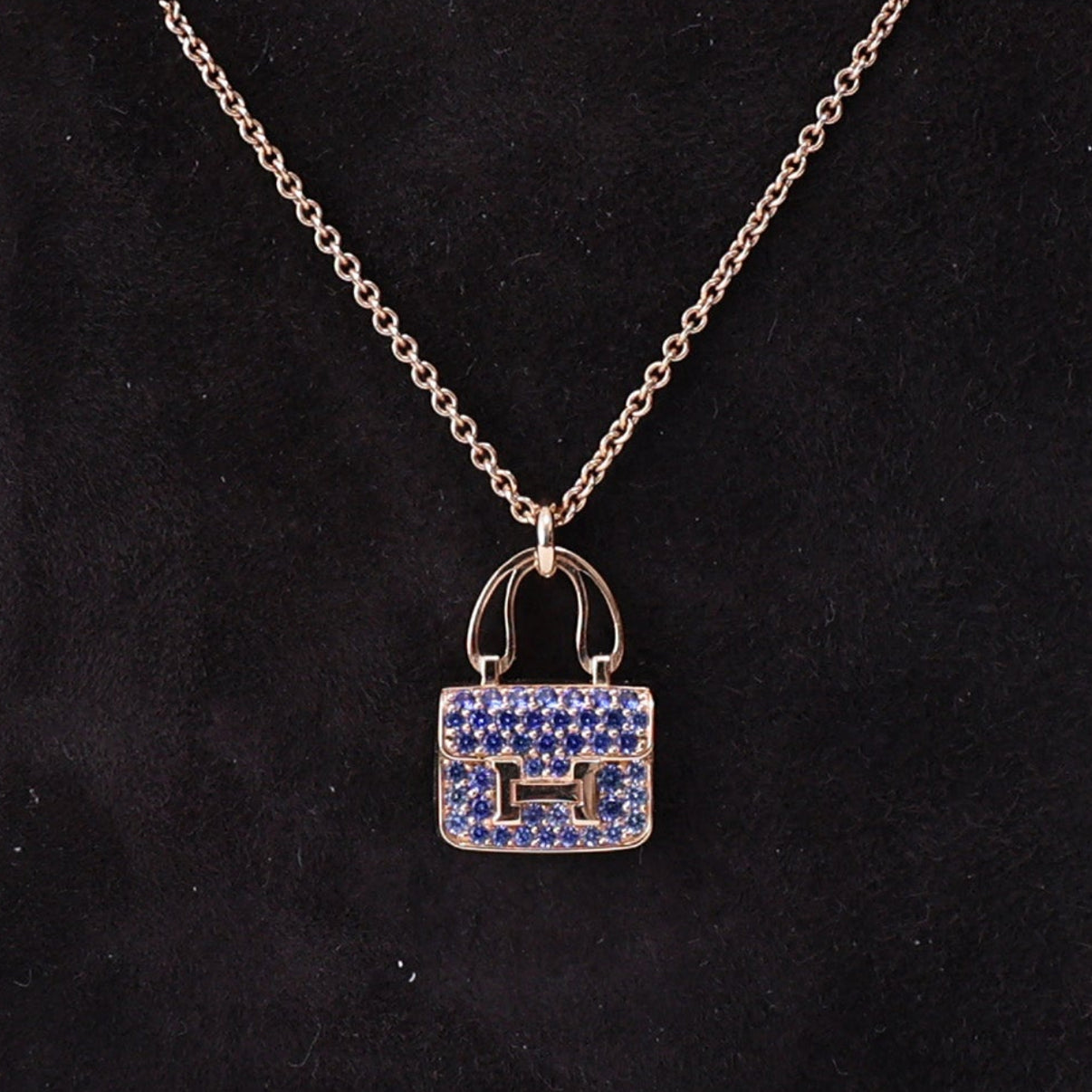 Hermès Amulettes Constance Pendant in Rose Gold with Blue Sapphires detail view