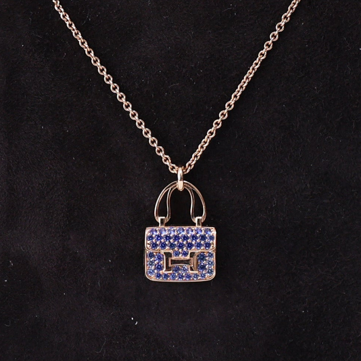 Hermès Amulettes Constance Pendant in Rose Gold with Blue Sapphires detail view