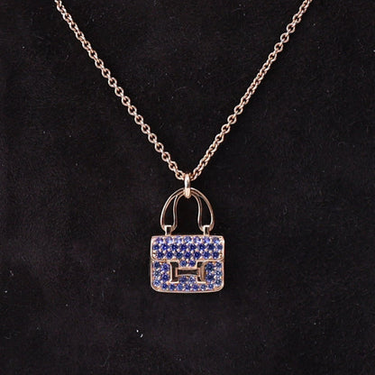 Hermès Amulettes Constance Pendant in Rose Gold with Blue Sapphires detail view