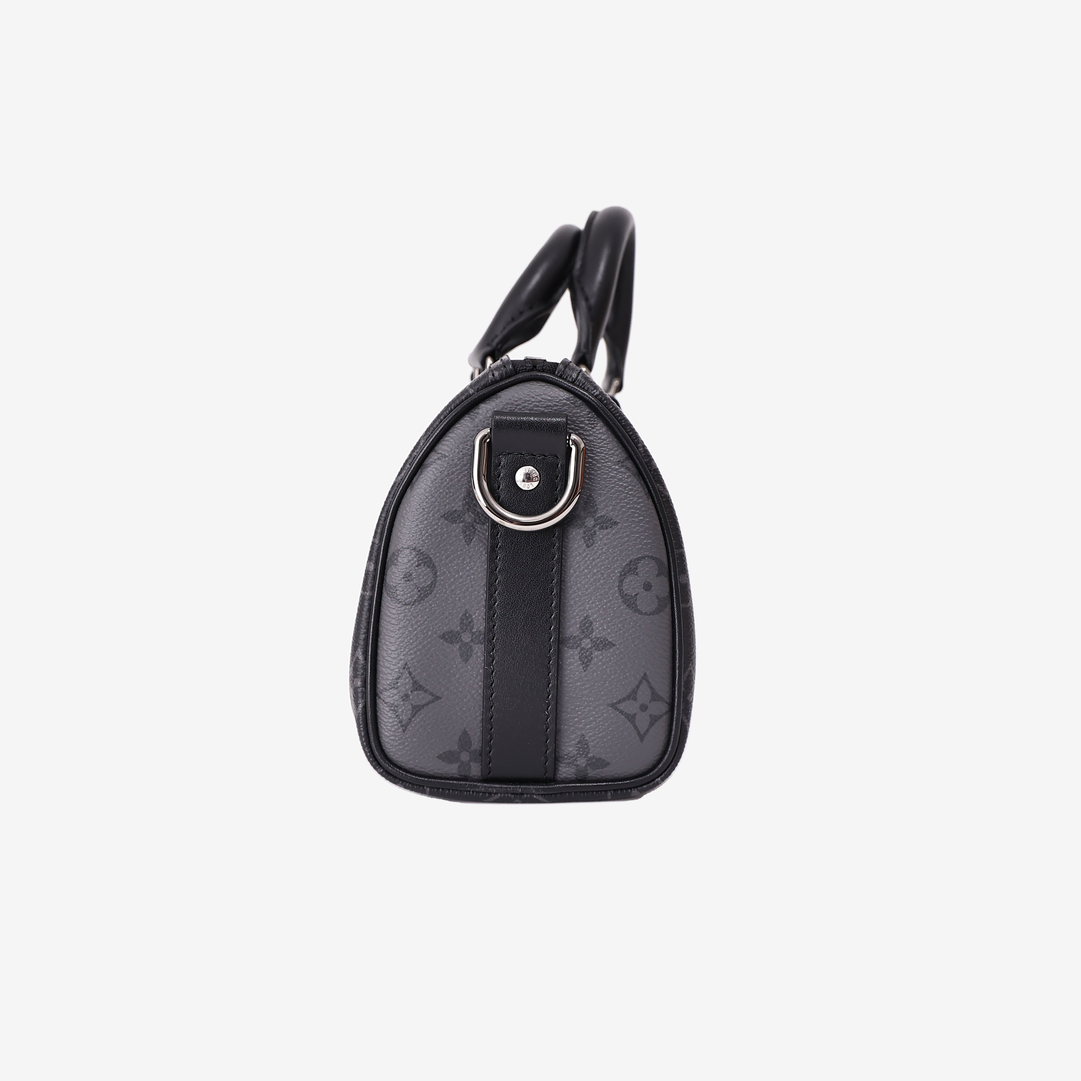 Louis Vuitton Keepall 25 in Monogram Eclipse Reverse Canvas with Black Leather Trim side view