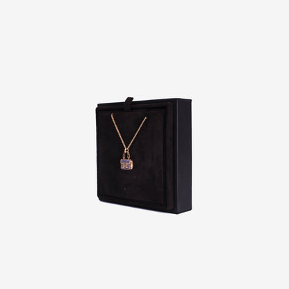 Hermès Amulettes Constance Pendant in Rose Gold with Blue Sapphires side view